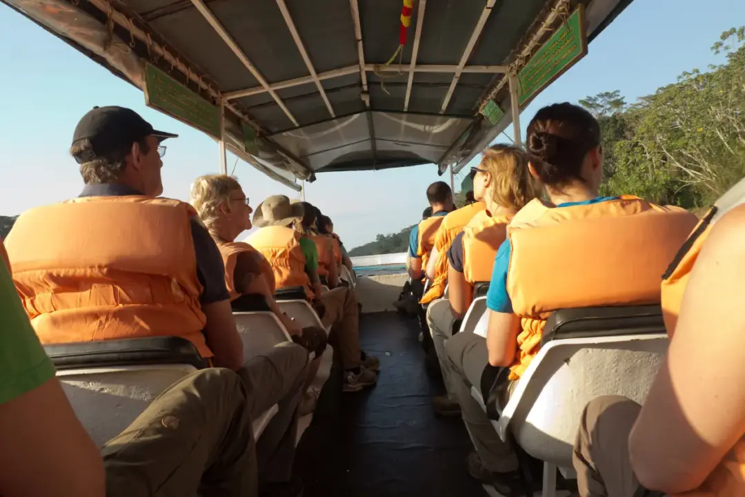 The Best Time to Visit Puerto Maldonado tourist in a jungle boat with life jackets
