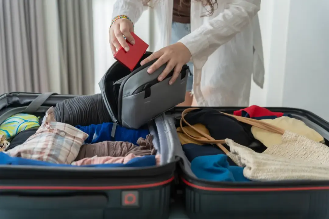 Amazon Rainforest Packing List woman-packing-suitcase-on-bed