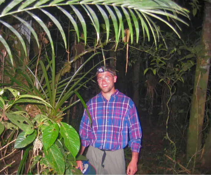 Nocturnal Explorations: A Thrilling Night Walk in Tambopata 26 Jungle Night Walk a man standing on amazon dark place