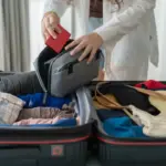 Amazon Rainforest Packing List woman packing suitcase on bed